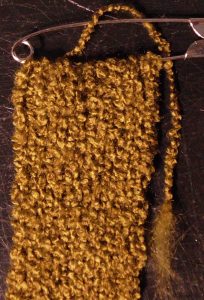 knit a long bit of ribbing and use a safety pin to stop it unraveling